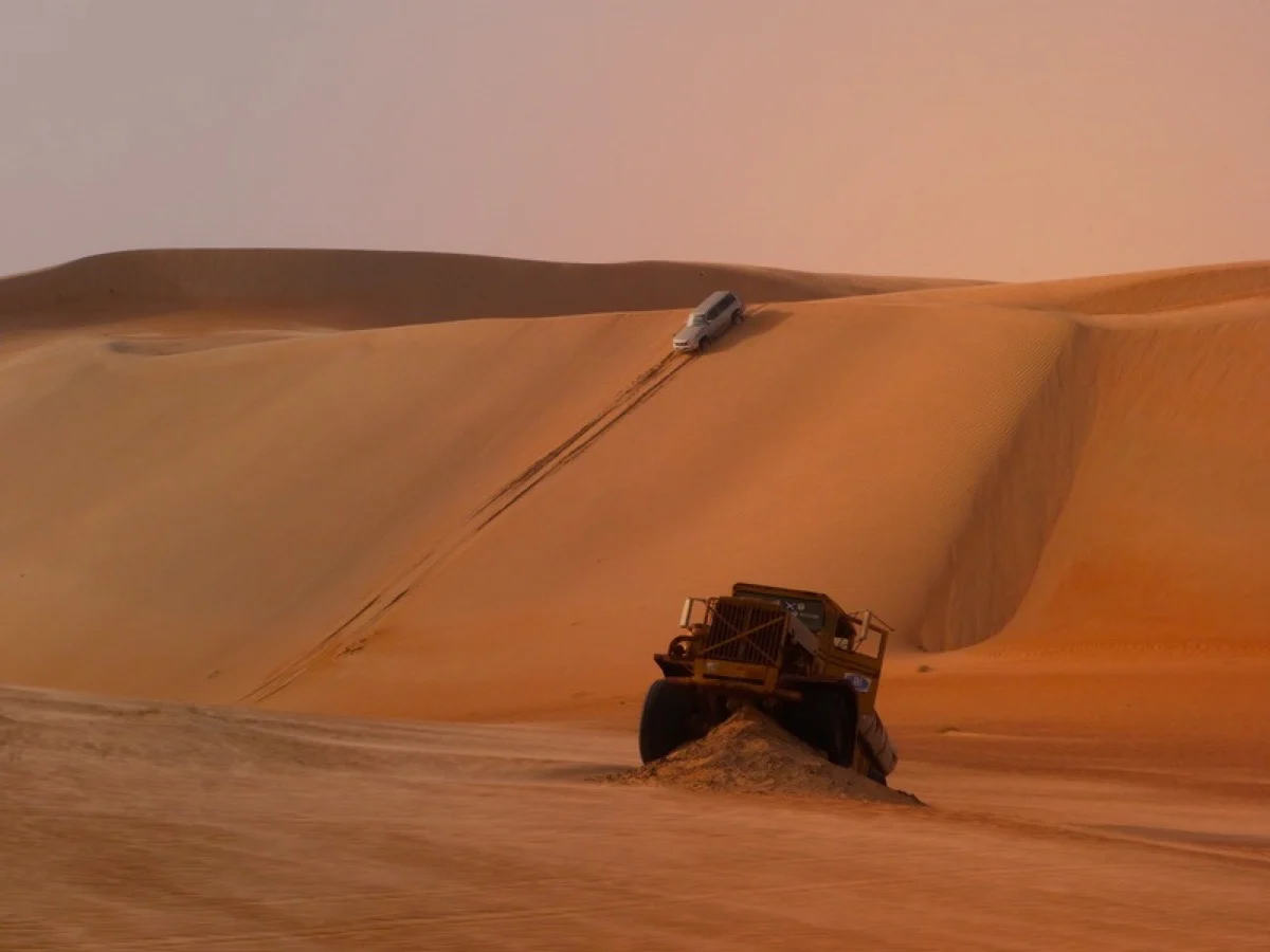 Vehicle tracks running over a desert dune